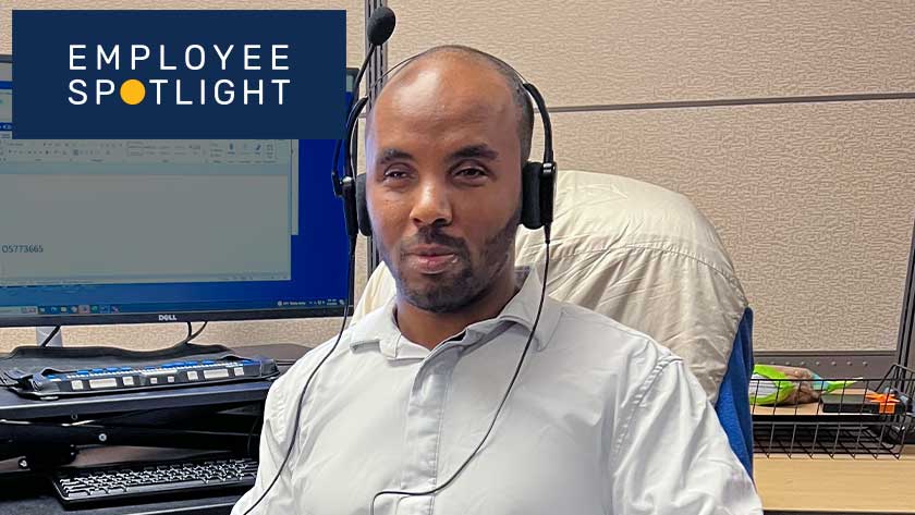 Man wearing headphones working on a computer with text overlay that reads "IBVI employee spotlight"