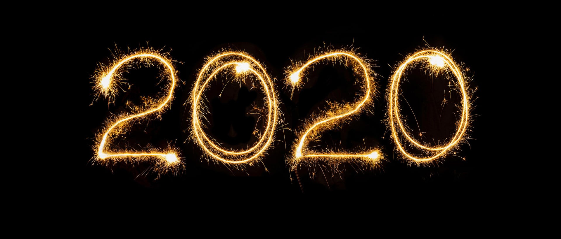 the numbers 2020 written with sparklers