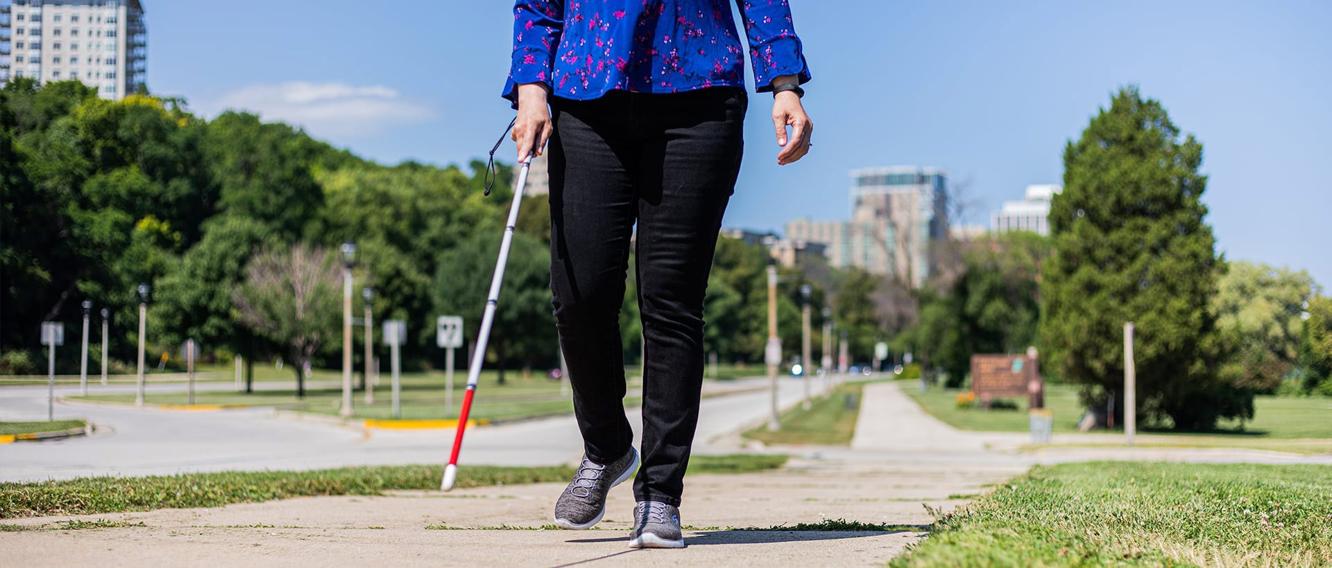 blind woman walking down a city street