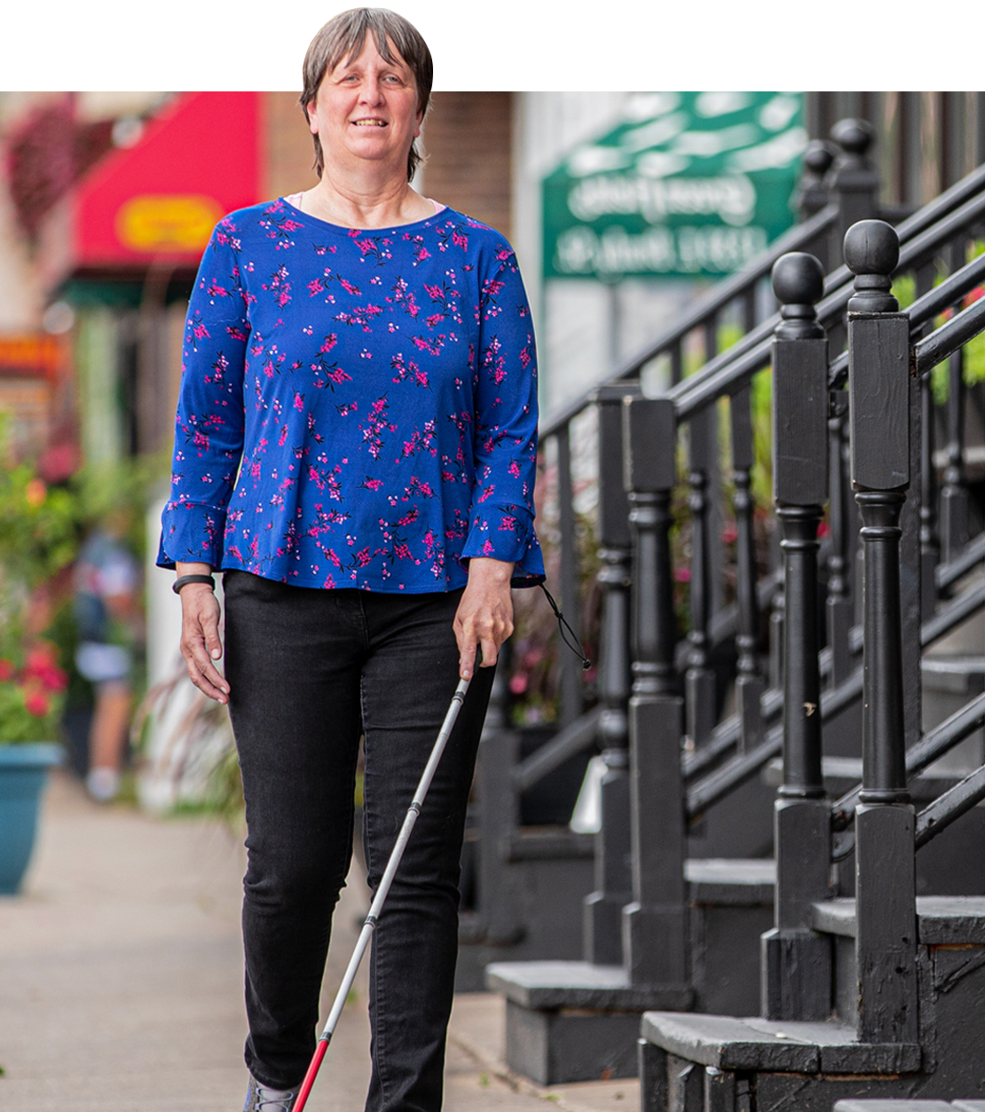 woman walking down the street with a cane