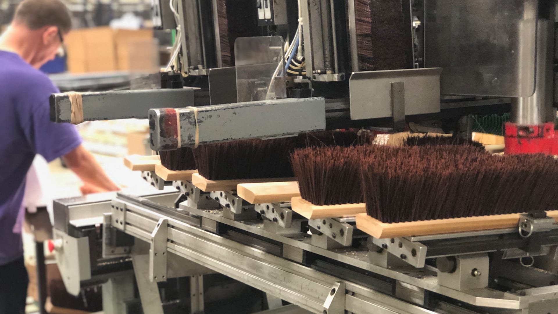 brooms being manufactured