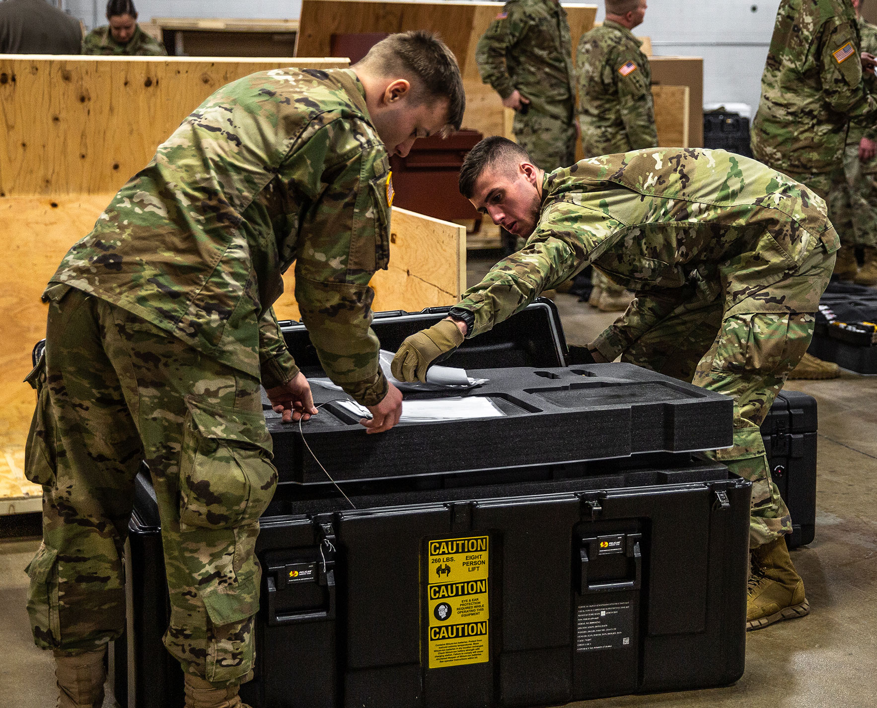 military men packing up kits