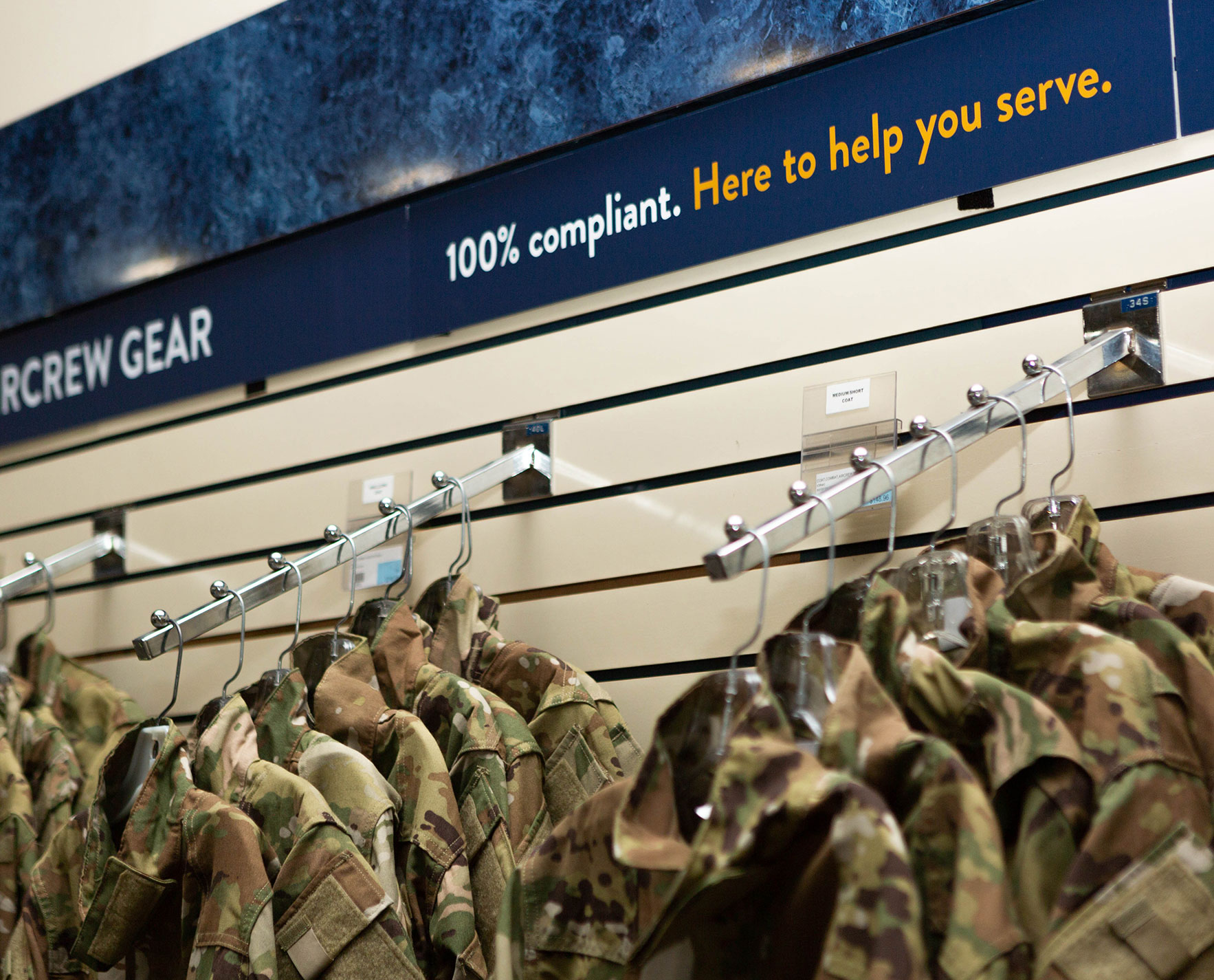 military jackets hanging on racks in a store